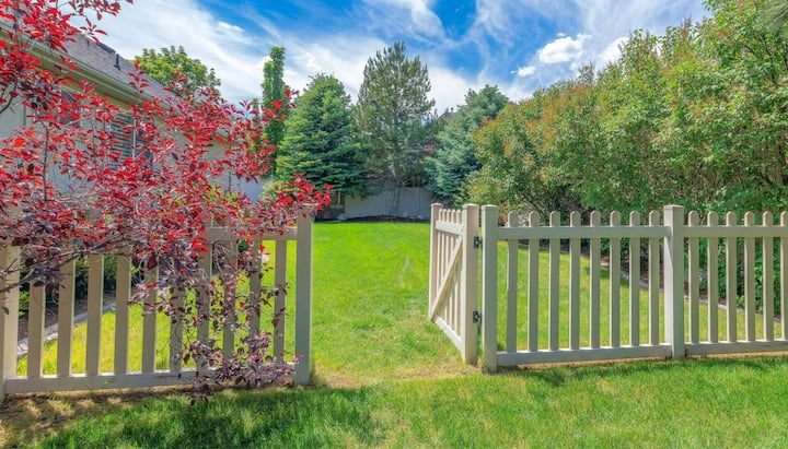 A functional fence gate providing access to a well-maintained backyard, surrounded by a wooden fence in Albuquerque